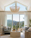 Modern living room with large windows, neutral decor, and a mountain view.