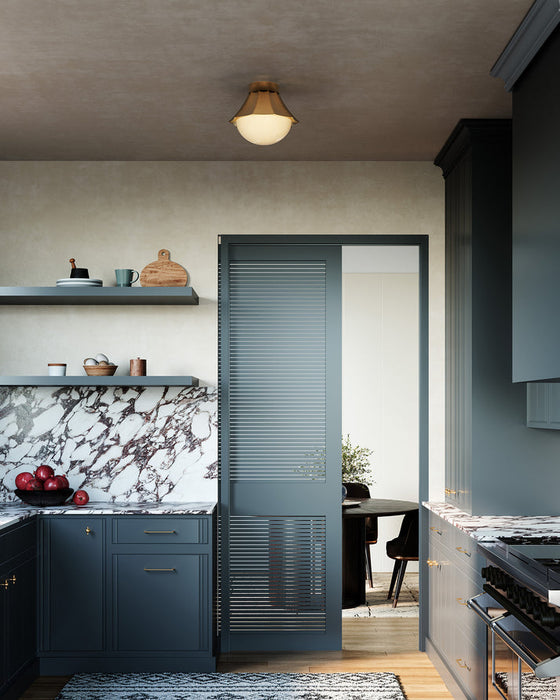 Modern kitchen with dark blue cabinets and a marble backsplash.