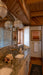 Bathroom with marble countertop, large mirror, and wooden ceiling.