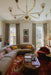 Living room with a chandelier, sectional sofa, and coffee table.