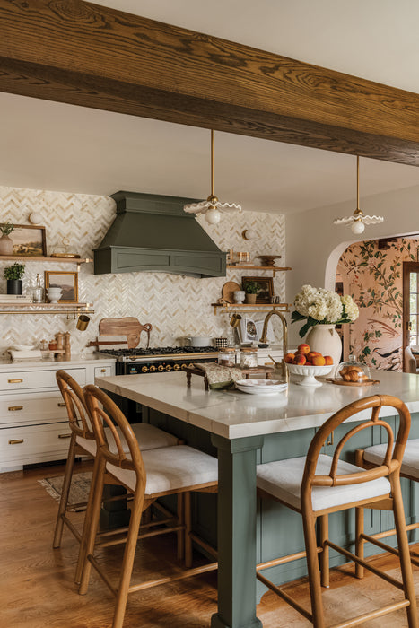 Kitchen with wooden dining table and chairs, marble countertop, and decorative elements.