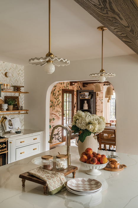 Kitchen with marble island, fruit bowl, and decorative elements.