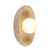 Oval travertine wall light with a glowing white globe center.