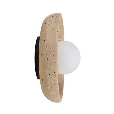 Wall light with a round white globe set in a curved beige stone frame.