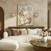 Modern neutral-toned living room with curved white sectional sofa, abstract wall art, and matching stone wall sconces.