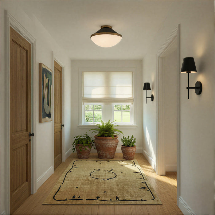Modern home hallway with two black sconces hanging on the wall.