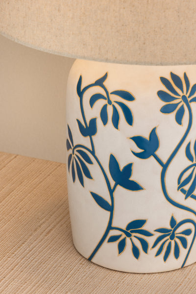 Ceramic lamp base with blue floral patterns on a beige background
