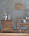 Wooden furniture set with decorative vases against a patterned wall.