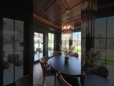 Contemporary room featuring a decorative light fixture as the main focal point. The fixture emits a soft, warm glow that spreads evenly across the space. The surrounding interior includes modern furnishings, clean lines, and a neutral color palette, creating a calm and inviting atmosphere. The camera moves slowly, showing both detailed views of the fixture and wider angles of how the lighting enhances the room