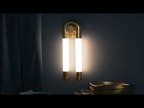 Wall-mounted sconce featuring an integrated LED light source with an etched cloud glass shade that softly diffuses light into a gentle, even glow. The glass has a subtle, cloudy texture that adds depth and softness. Vintage polished brass detailing provides a warm metallic contrast, while the fixture casts a smooth, ambient light across the wall.