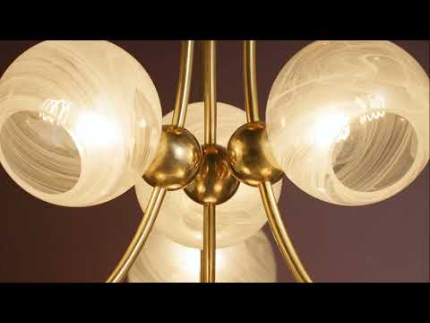 Chandelier-style light fixture suspended from the ceiling, featuring multiple ball-shaped glass shades. Each rounded shade softly diffuses light, creating a warm, even glow. The spherical forms are evenly spaced, giving the fixture a balanced, modern look while casting gentle ambient light throughout the space.