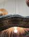 Close-up of a woven basket with a blurred light source in the background