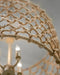 Close-up of a textured beige lampshade with a blurred chandelier in the background.